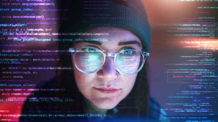 Picture of a young woman looking at a computer screen face forward