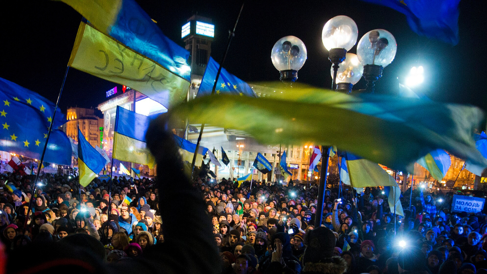 Group of people demonstrating with Ukrainian flags